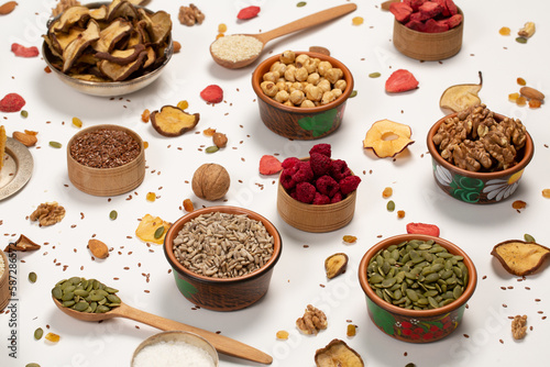 Healthy vegetarian food concept. Assortment of dried fruits, nuts and seeds on white background. Top view. 