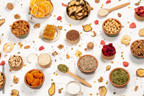  Healthy vegetarian food concept. Assortment of dried fruits, nuts and seeds on white background. Top view. © romeof