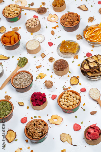  Healthy vegetarian food concept. Assortment of dried fruits, nuts and seeds on white background. Top view. 