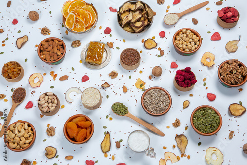  Healthy vegetarian food concept. Assortment of dried fruits, nuts and seeds on white background. Top view. © romeof