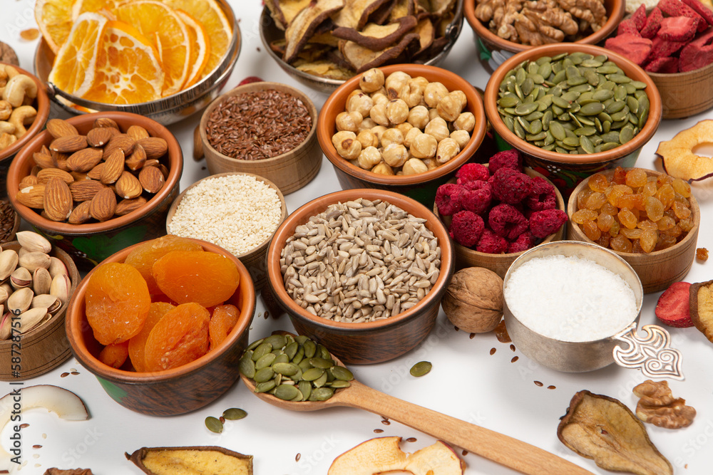 Healthy vegetarian food concept. Assortment of dried fruits, nuts and seeds on white background. Top view.