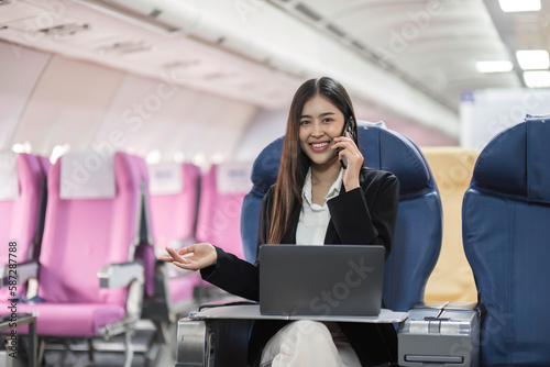 tourism and technology concept of business woman with smartphone and laptop