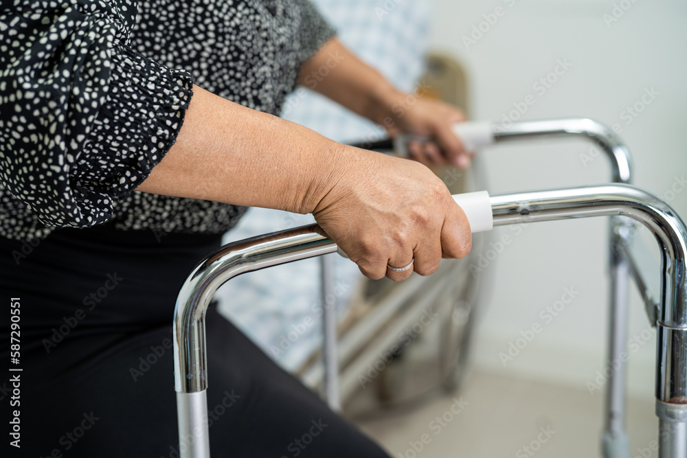 Asian lady patient use walker to help waliking support for orthopedic lumbar. Asian lady patient use walker to help waliking support for orthopedic lumbar.