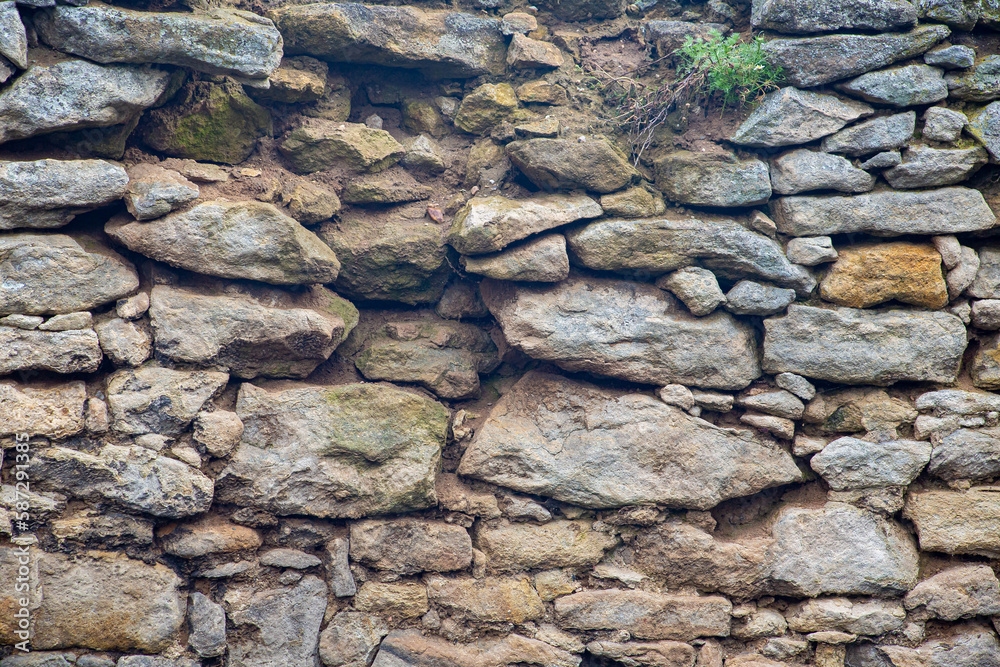 Old solid stone wall, weathered worn wallpaper texture Old solid stone wall, weathered worn wallpaper texture