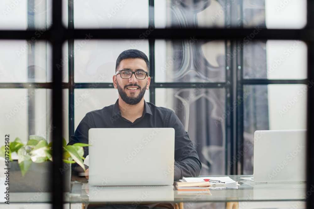 Fototapeta premium Middle-aged man working on laptop in office