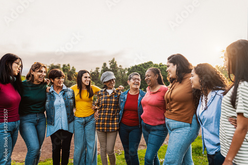 Happy multigenerational group of women with different ethnicities having fun in a public park - Females empowerment concept