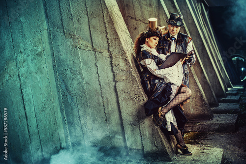 Portrait of a young beautiful couple in steampunk style. Victorian woman and man in alternative history.