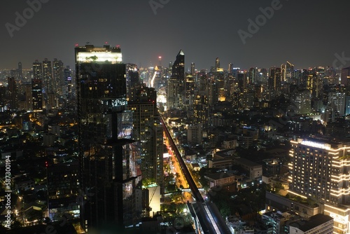 Spectacular view over the city lights of Bankok in Thailand at night photographed from a rooftop bar. photo