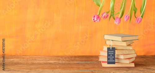 new book releases with hang tag with caption fresh ideas in spring and summer and flowers, spring book fair, inspiration,reading, education, literature concept, free copy space