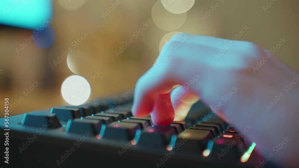 Player Uses Male Teenager Gaming Keyboard Night of bokeh light bulbs garlands. Cyberspace. Blur Hands Gamer Plays Video Game Close up Typing on Computer Keyboard in Neon Lighting Player Uses Male Teenager Gaming Keyboard Night of bokeh light bulbs garlands. Cyberspace. Blur Hands Gamer Plays Video Game Close up Typing on Computer Keyboard in Neon Lighting