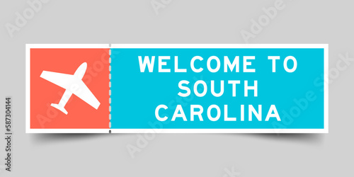 Orange and blue color ticket with plane icon and word welcome to south carolina on gray background