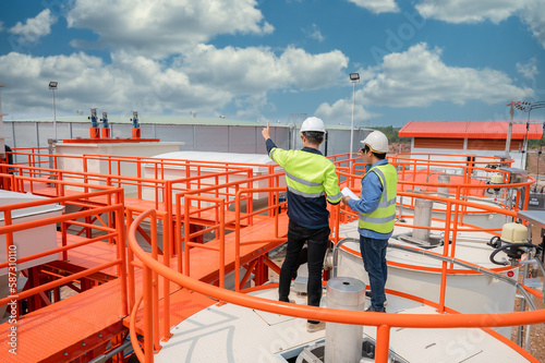2 male industrial engineers and architects Work to inspect water systems and water tank systems in engineering plants