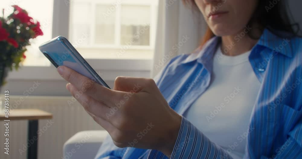 Woman hand holding cell phone touch screen typing scroll page using app Woman hand holding cell phone touch screen typing scroll page using app