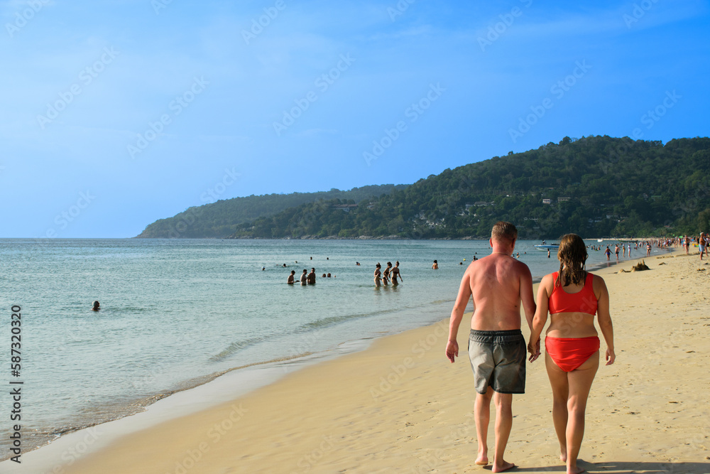 Romantic mature couple walking on the beach at vacation Romantic mature couple walking on the beach at vacation