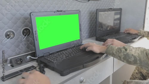Military drone control. Military drone control point. A military man controls a drone on a laptop.