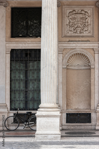 Parked bicycle next to ancient columns on a street in Rome. Selective focus