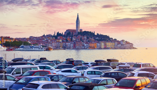 Rovinj Croatia. Sunrise sky above vintage town at Istria peninsula in Adriatic Sea. View from cars parking. Old Mediterranean architecture and buildings. Coastline tower of Church Saint Euphemia