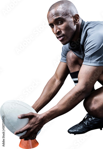 Portrait of sportsman keeping rugby ball on kicking tee