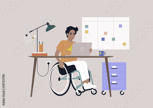 A young Hispanic person using a wheelchair works at a desk in the office