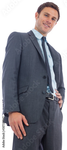 Cheerful businessman with hand on hip