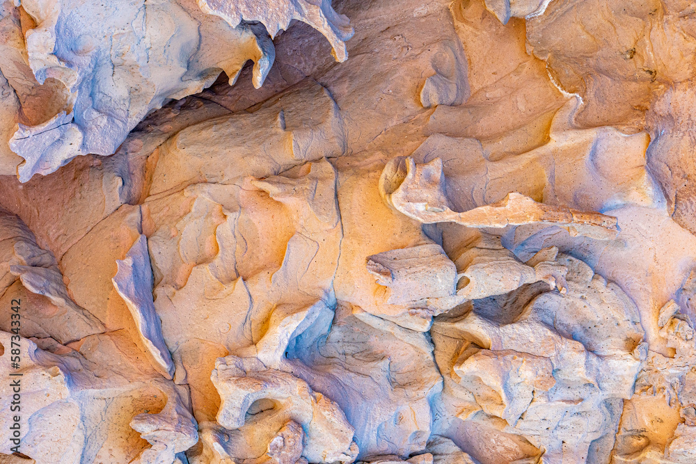Naklejka premium Close-up of wall of rocky massif in the Cerro de la Calavera, rock formation with irregular texture, grooves and erosions caused by passage of time, sunny day in La Paz, Baja California Sur Mexico