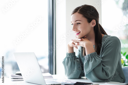 Happy businesswoman working with laptop. business concept