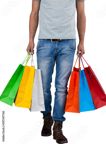 Low section of man carrying colorful shopping bag against white background