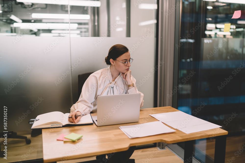 Focused lawyer with laptop and documents in workplace Focused lawyer with laptop and documents in workplace