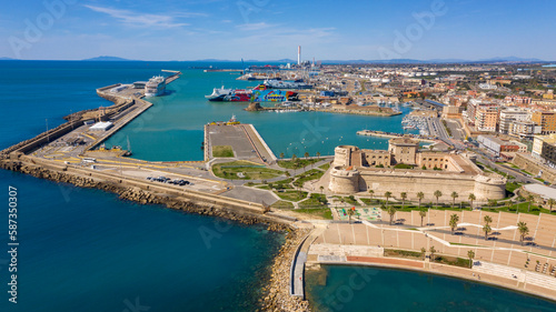Aerial view of Fort Michelangelo, located in the port of Civitavecchia, in the Metropolitan City of Rome, Italy. In the background are ferries and cruise ships.  photo