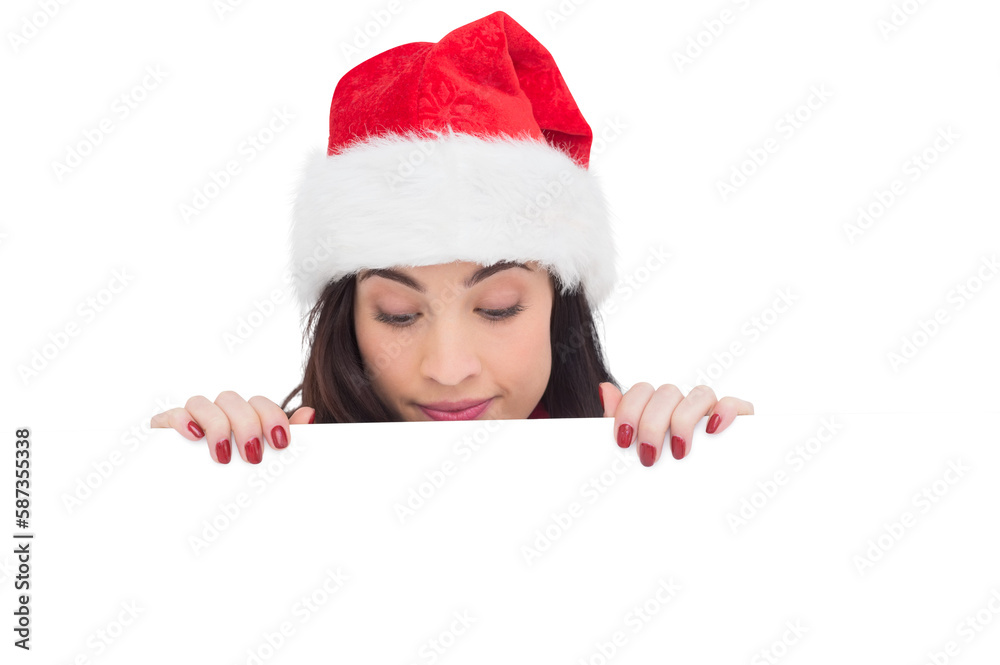 Pretty brunette in santa hat showing white poster Pretty brunette in santa hat showing white poster