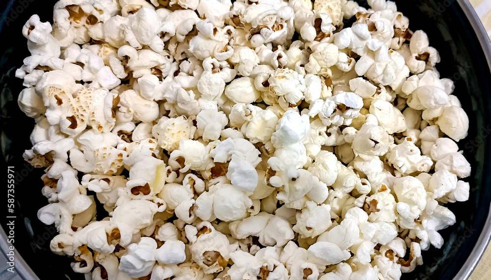 A closeup view of bowl of popcorn on a wooden table