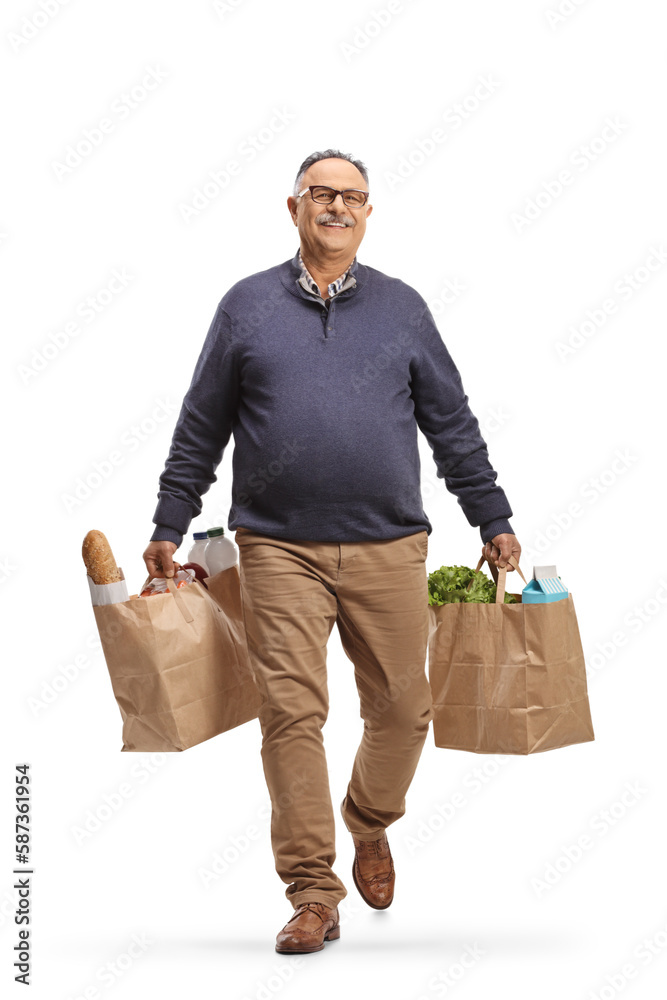 Full length portrait of a mature man carrying grocery bags Full length portrait of a mature man carrying grocery bags