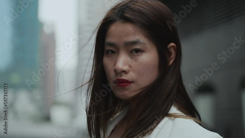 Wallpaper Mural Chinese women stand and stare at the camera in Chengdu China, woman's face was expressionless,breeze blowing her hair Torontodigital.ca
