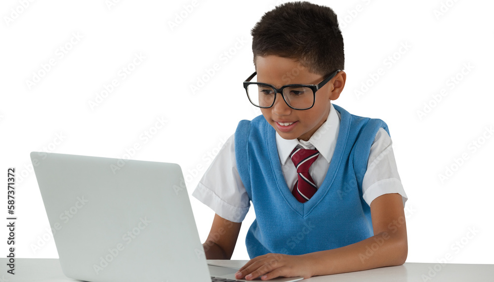Schoolboy using laptop at table Schoolboy using laptop at table