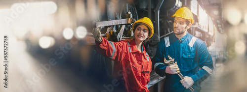 Female engineer and worker checking equipment in factory for repair