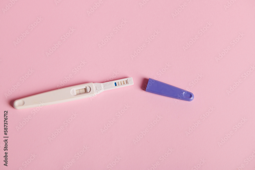 Still life. Inkjet pregnancy test with a positive result between human chorionic gonadotropin in the urine, isolated on a pink pastel background. Finally pregnant. Quick Pregnancy Detection. Still life. Inkjet pregnancy test with a positive result between human chorionic gonadotropin in the urine, isolated on a pink pastel background. Finally pregnant. Quick Pregnancy Detection.