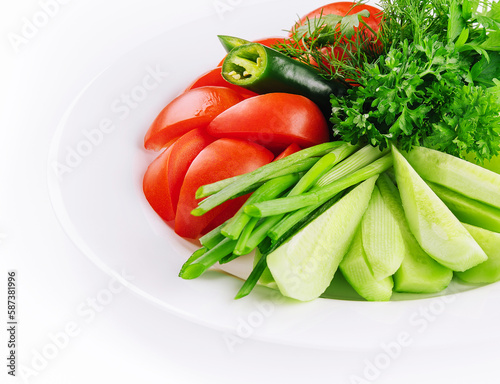 Vegan plate of fresh sliced cucumbers, green onions and cherry tomatoes