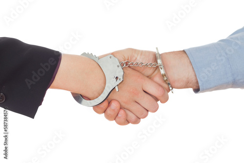 Business people in handcuffs shaking hands