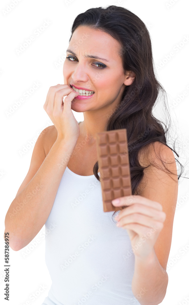 Pretty brunette fearfully looking at chocolate Pretty brunette fearfully looking at chocolate