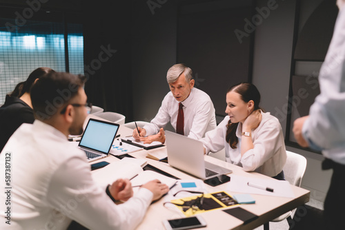 Group of coworkers sitting at table during conference