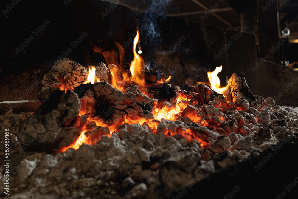 Barbecue Grill Pit With Glowing And Flaming Hot Charcoal Briquettes, Close-Up Barbecue Grill Pit With Glowing And Flaming Hot Charcoal Briquettes, Close-Up