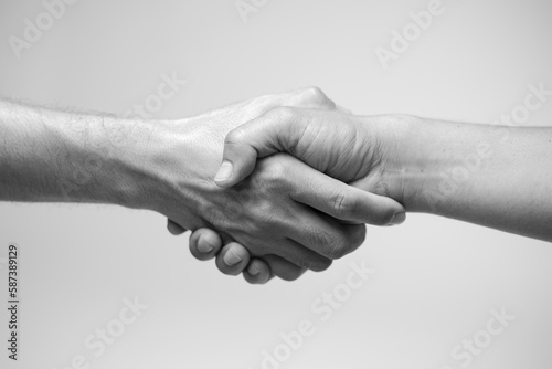 Close up two man shaking hand on white background.Athletes shaking hands before sports competition. Unity and teamwork concept.Black and white tone. photo