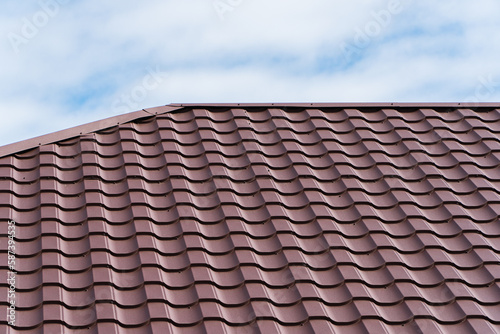 Brown corrugated metal profile roof. Modern roof made of metal