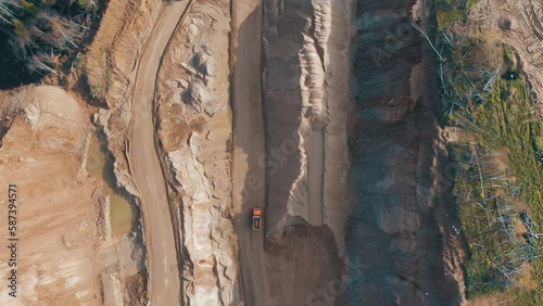 Mining truck moving at sand quarry aerial view of mining machinery moving at sand mine top view of mining equipment at sand mine mining industry heavy vehicle at sandpit