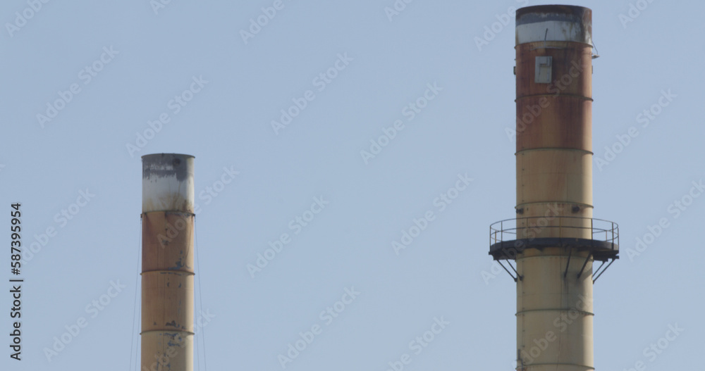 Smoke stacks against sky