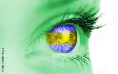 Blue and yellow eye on green face 