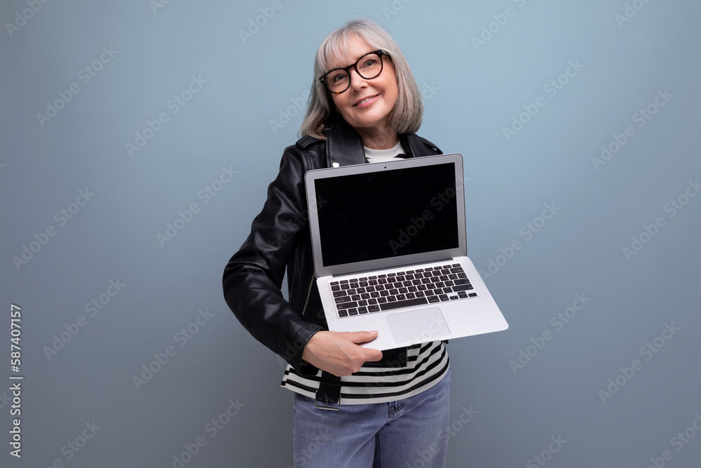smart modern 60s mature old business lady with gray hair demonstrates laptop ownership with mockup on bright background smart modern 60s mature old business lady with gray hair demonstrates laptop ownership with mockup on bright background