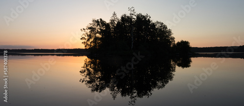 Panoramic view to s small island on a swedish lake in sunmer at sunrise. photo