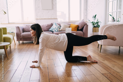 Woman doing prenatal yoga in One Legged Table pose