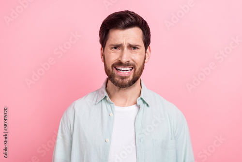 Photo of shocked impressed man wear turquoise shirt listening bad news isolated pink color background © deagreez